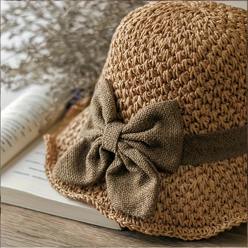 Elegant woven straw sun hat with a bow
