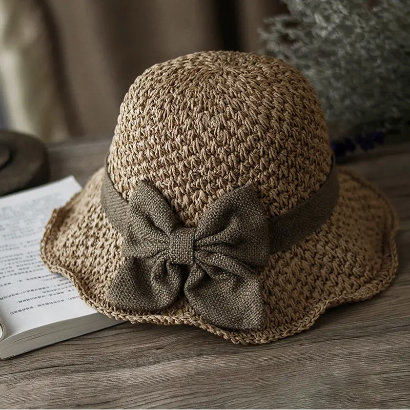Elegant woven straw sun hat with a bow